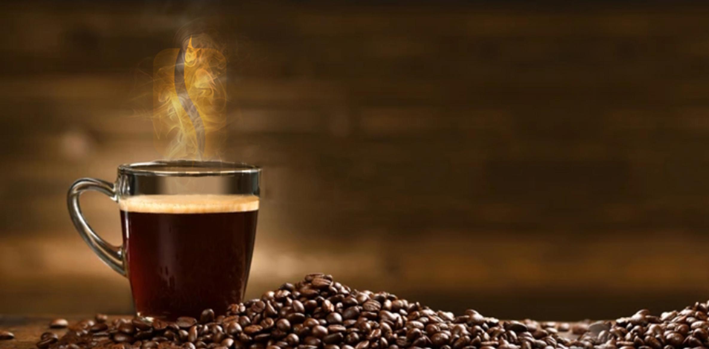 Why Ricco Coffee – Steaming Cup with Roasted Beans Steaming cup of coffee on a rustic wood table surrounded by roasted coffee beans, representing Ricco Coffee’s warm, artisan approach to craft roasting