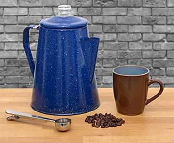 A classic coffee percolator surrounded by aromatic coffee beans and a waiting mug, embodying the essence of stove-top brewing perfection.