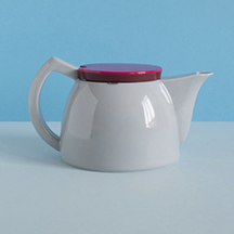 : The Sowden SoftBrew coffee maker with a vibrant red lid, displayed against a blue background, hinting at its versatility for brewing tea and other hot beverages.