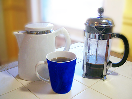 Sowden-SoftBrew-and-French-Press-Comparison.jpg A Sowden SoftBrew coffee pot next to a French press and a vibrant blue mug of coffee on a tiled countertop, showcasing different brewing methods.
