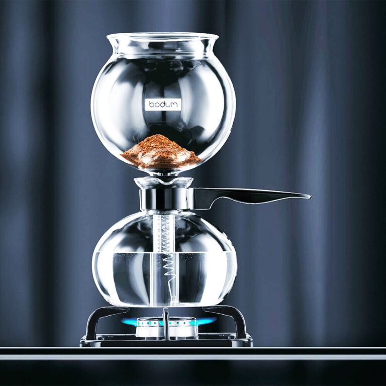 Promotional banner of Ricco Coffee Company with a steaming cup of coffee and text overlay "Why RICCO Coffee? Experience the flavors of mountain-grown coffee. It Will Spoil You For Life!" against a backdrop of coffee beans.