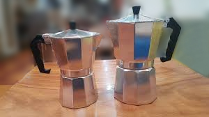 Large-Medium-Size-Moka-Pots-Conclusion A pair of Moka Pots in large and medium sizes displayed on a wooden surface, encapsulating the essence of Moka Pot coffee brewing as explored in the guide's conclusion.
